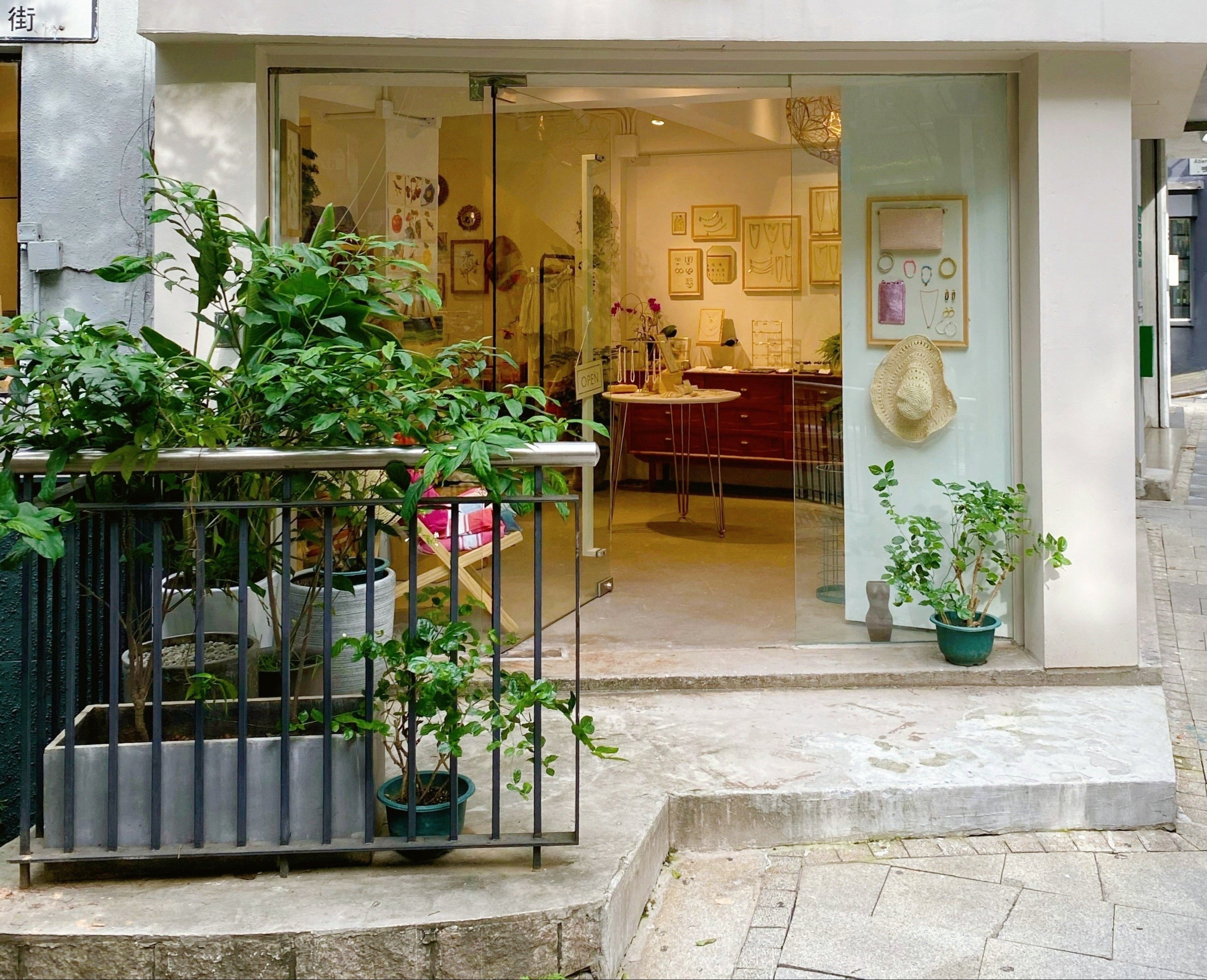 Storefront of Green Lemon with glass doors and plants outside