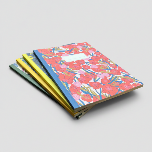 Stack of notebooks with floral and colorful designs on a light gray background