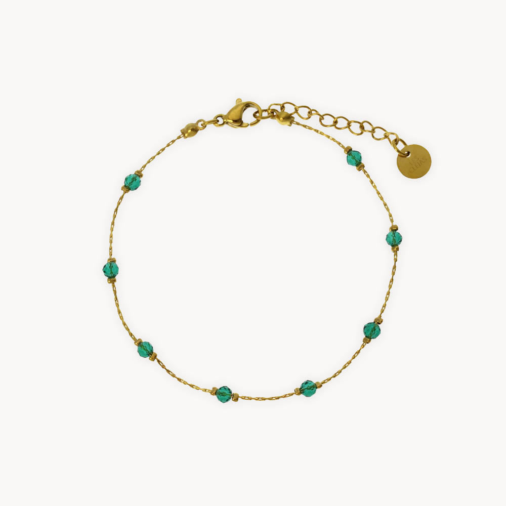 Gold bracelet with green crystal beads
