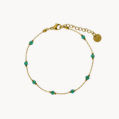 Gold bracelet with green crystal beads