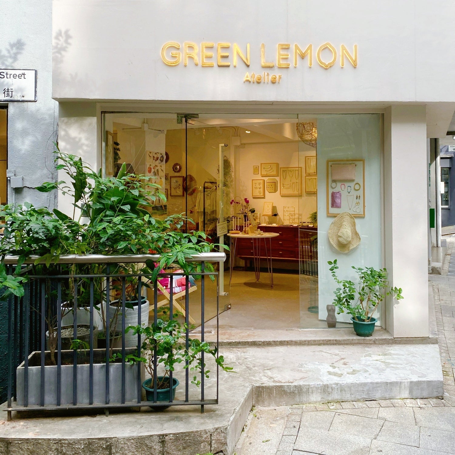Storefront of Green Lemon with glass doors and plants outside
