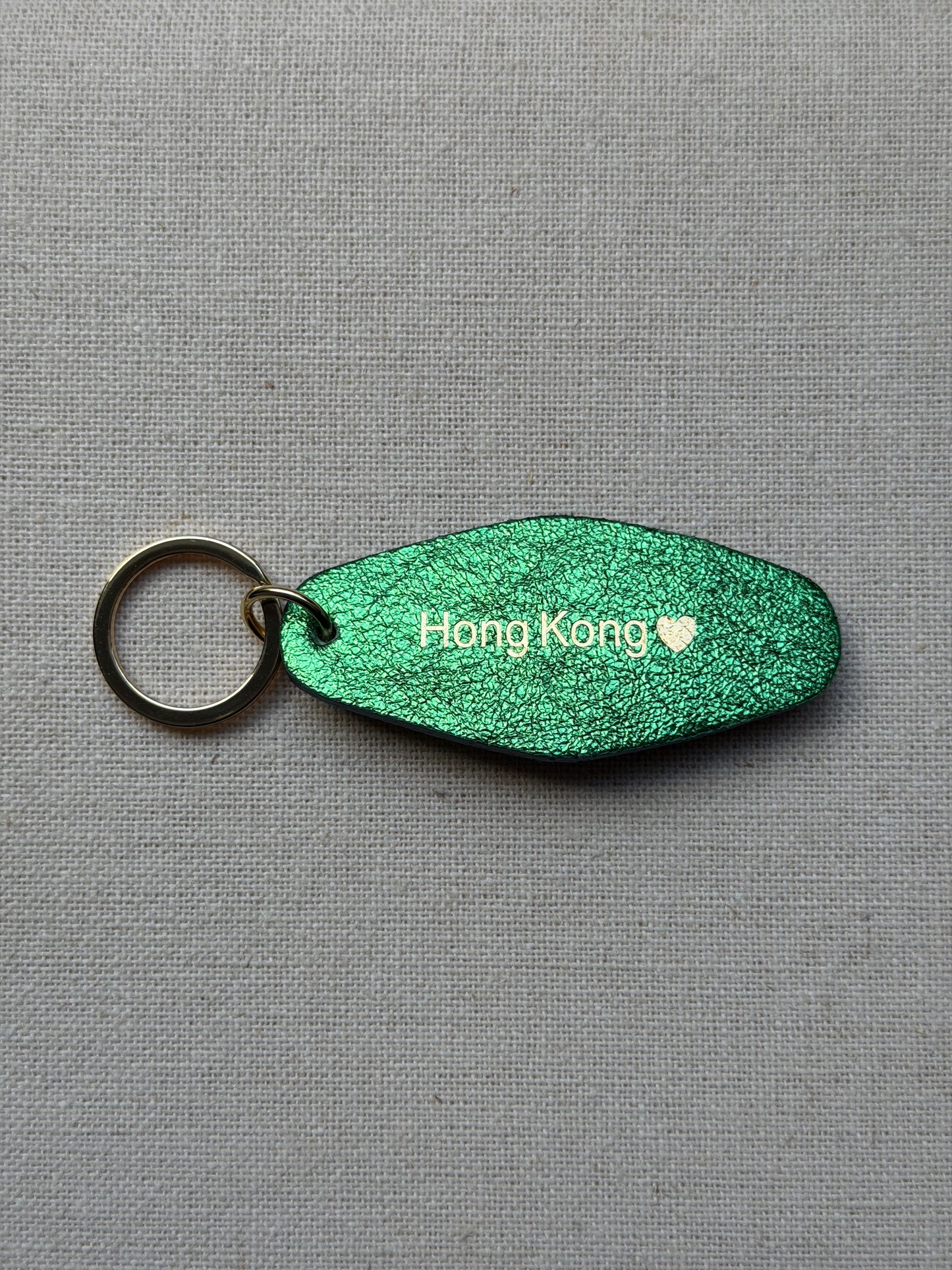 Iridescent Green Leather Keychain with Hong Kong on it
