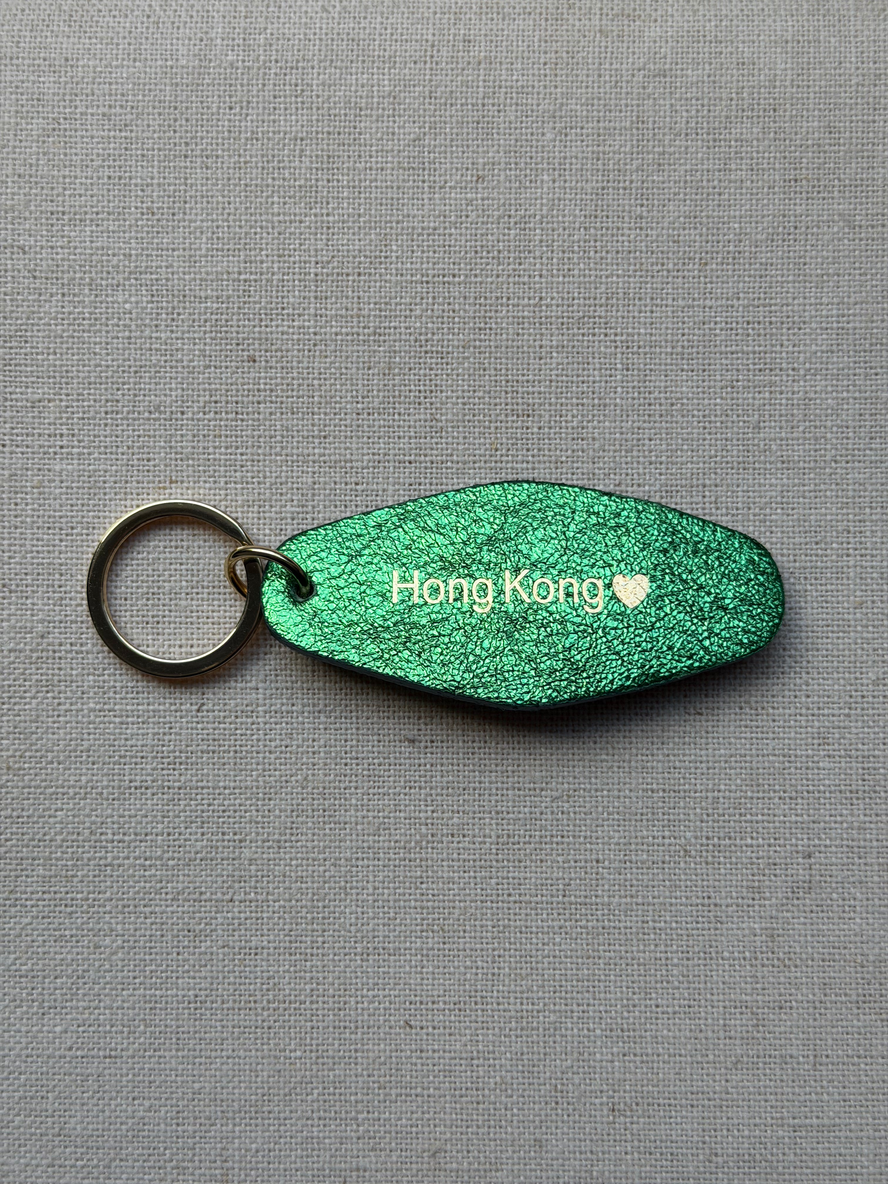 Iridescent Green Leather Keychain with Hong Kong on it
