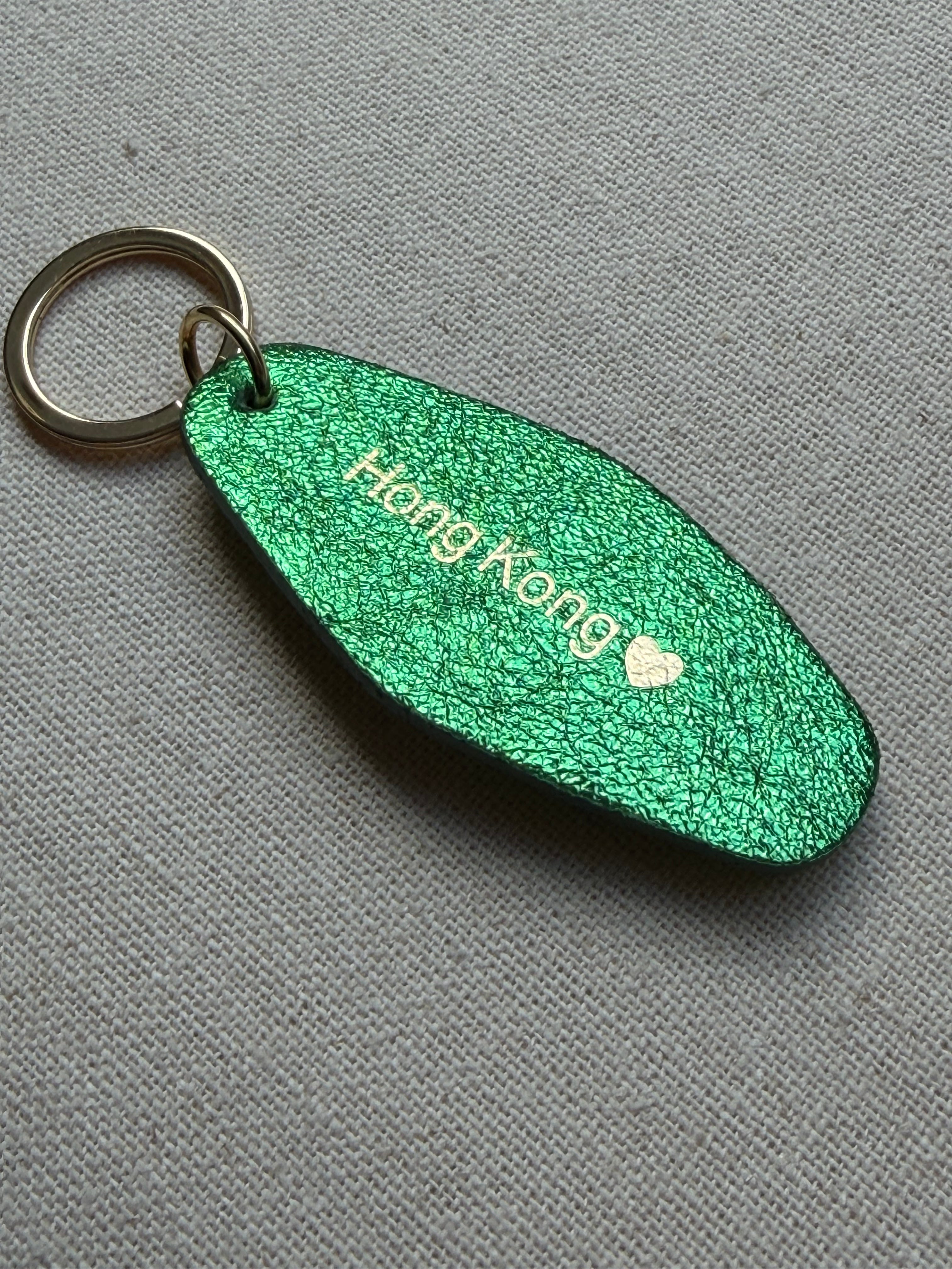 Iridescent green Leather Keychain with Hong Kong on it
