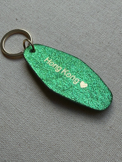 Iridescent green Leather Keychain with Hong Kong on it
