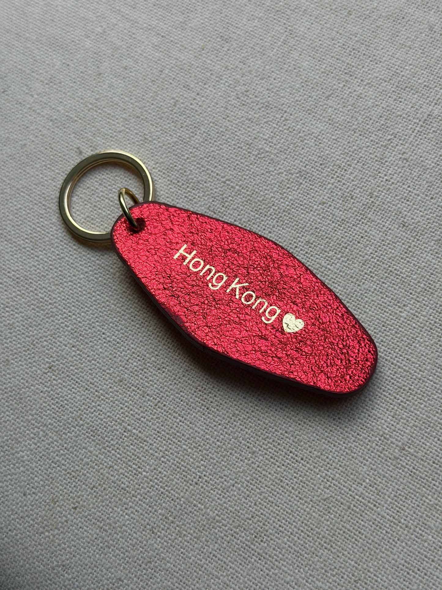 Iridescent red Leather Keychain with Hong Kong on it
