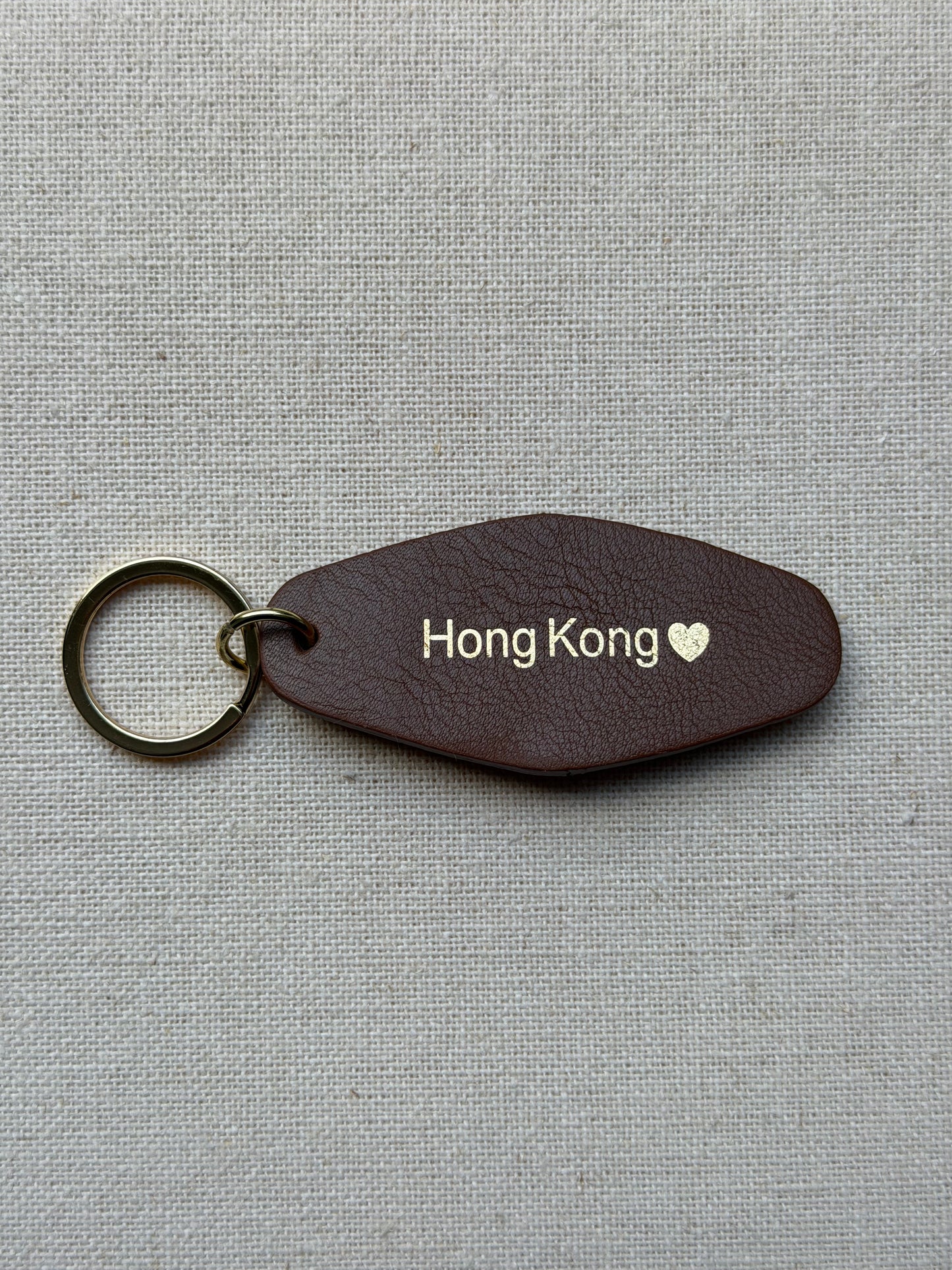 brown Leather Keychain with Hong Kong on it