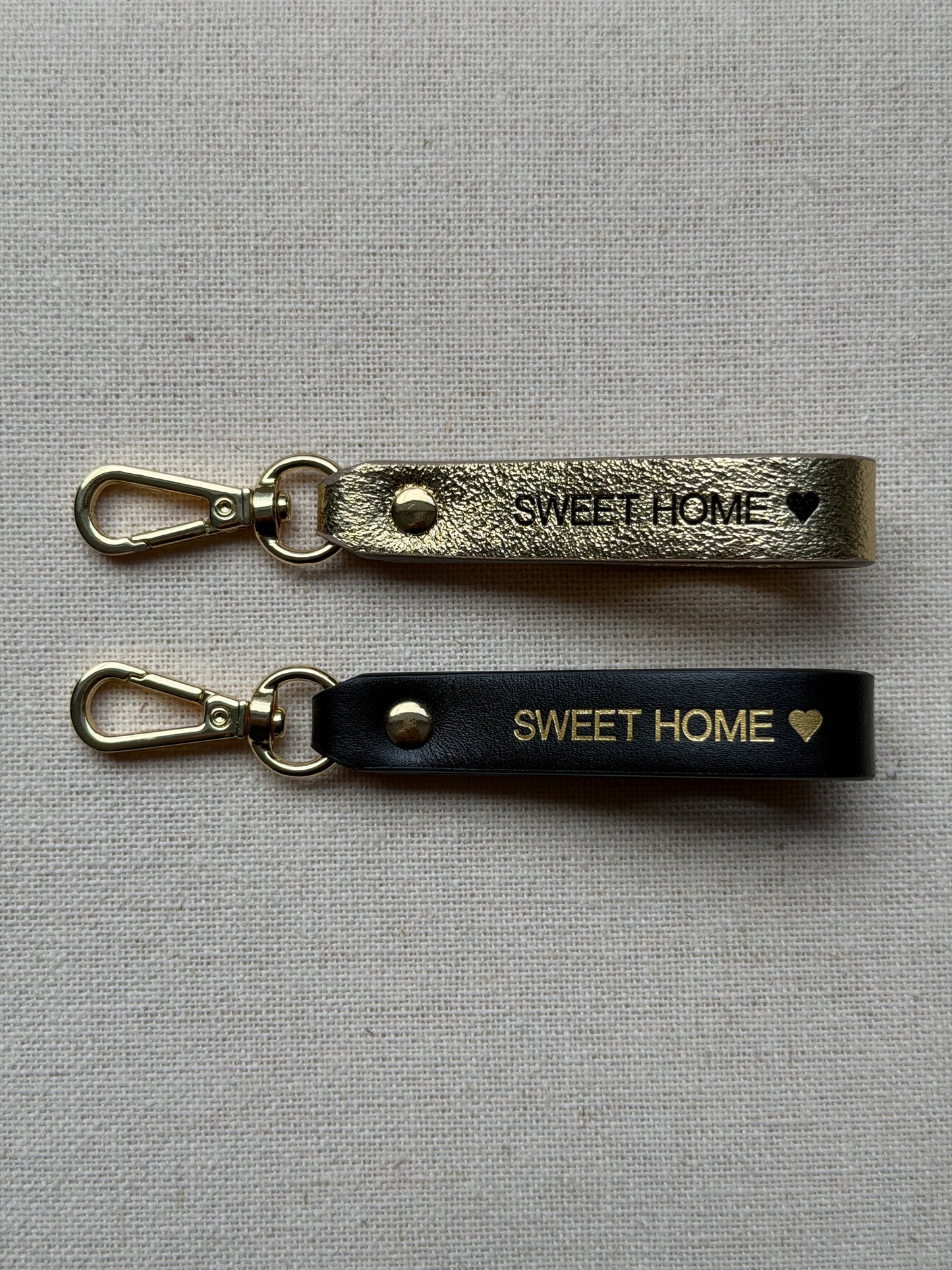 Stylish leather keychain with leash, with "Sweet Home" printed on it