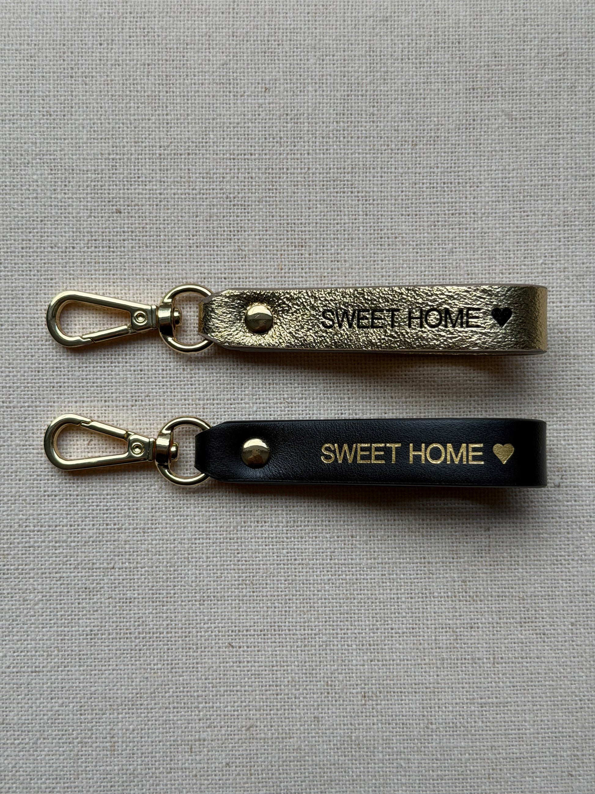 Stylish leather keychain with leash, with "Sweet Home" printed on it