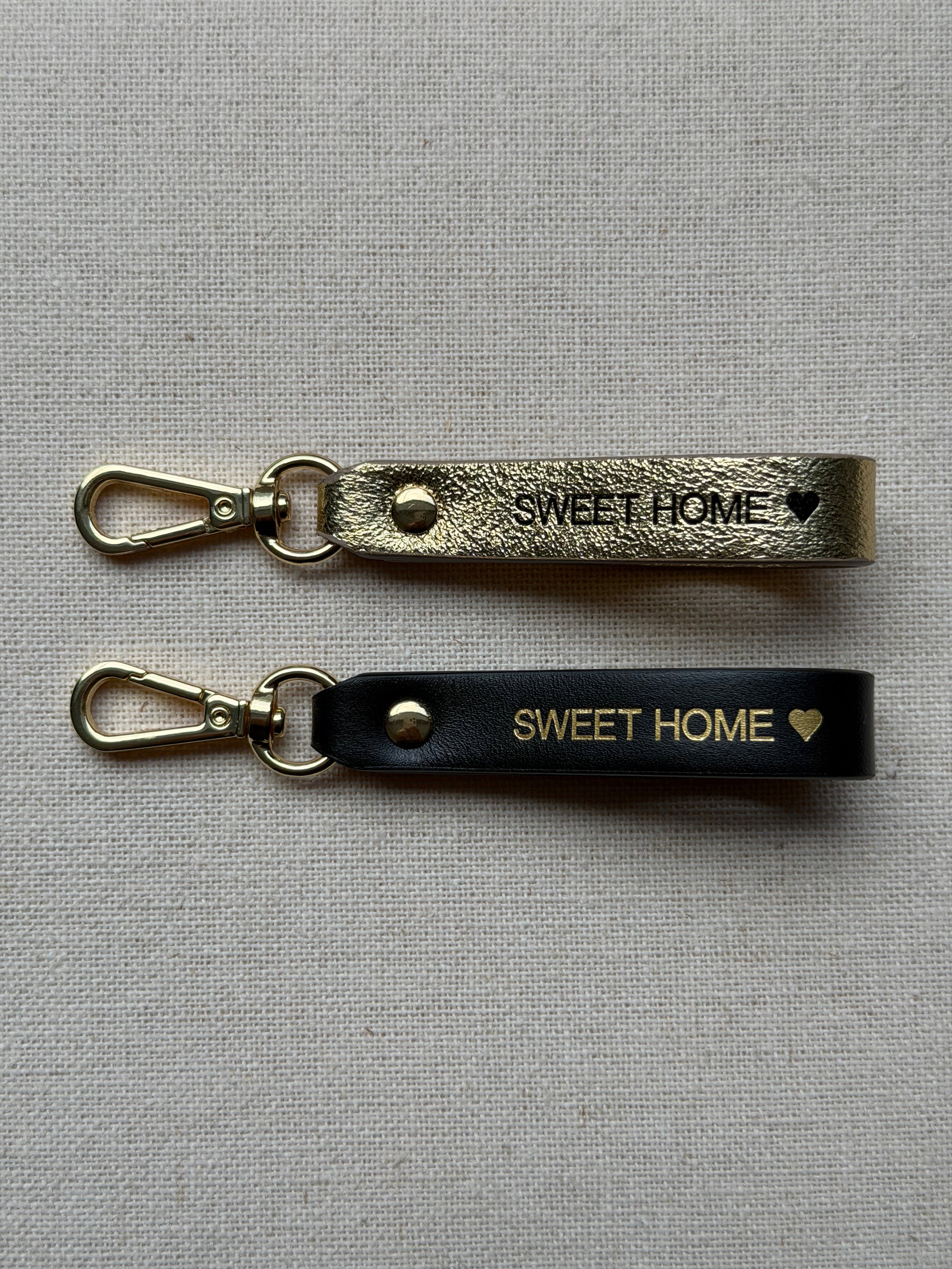Stylish leather keychain with leash, with "Sweet Home" printed on it