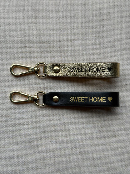 Stylish leather keychain with leash, with "Sweet Home" printed on it