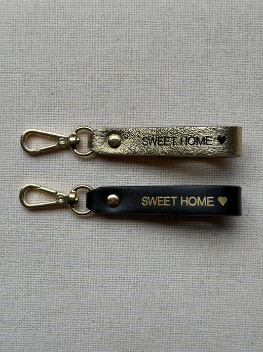 Stylish leather keychain with leash, with "Sweet Home" printed on it