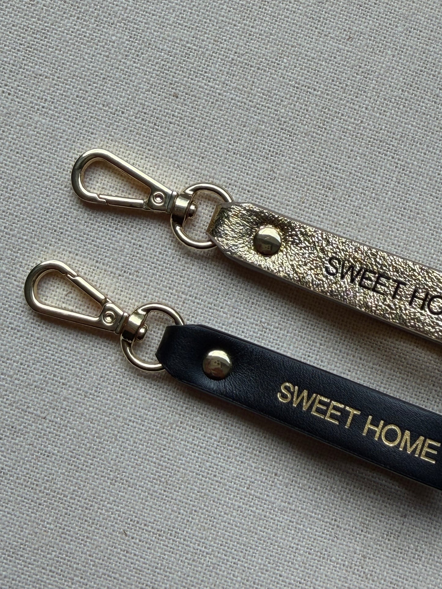 Stylish leather keychain with leash, with "Sweet Home" printed on it