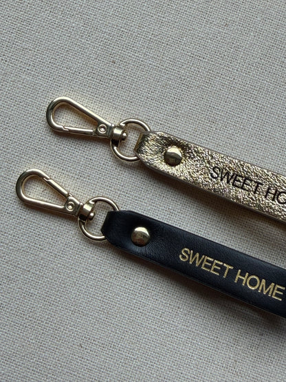 Stylish leather keychain with leash, with "Sweet Home" printed on it