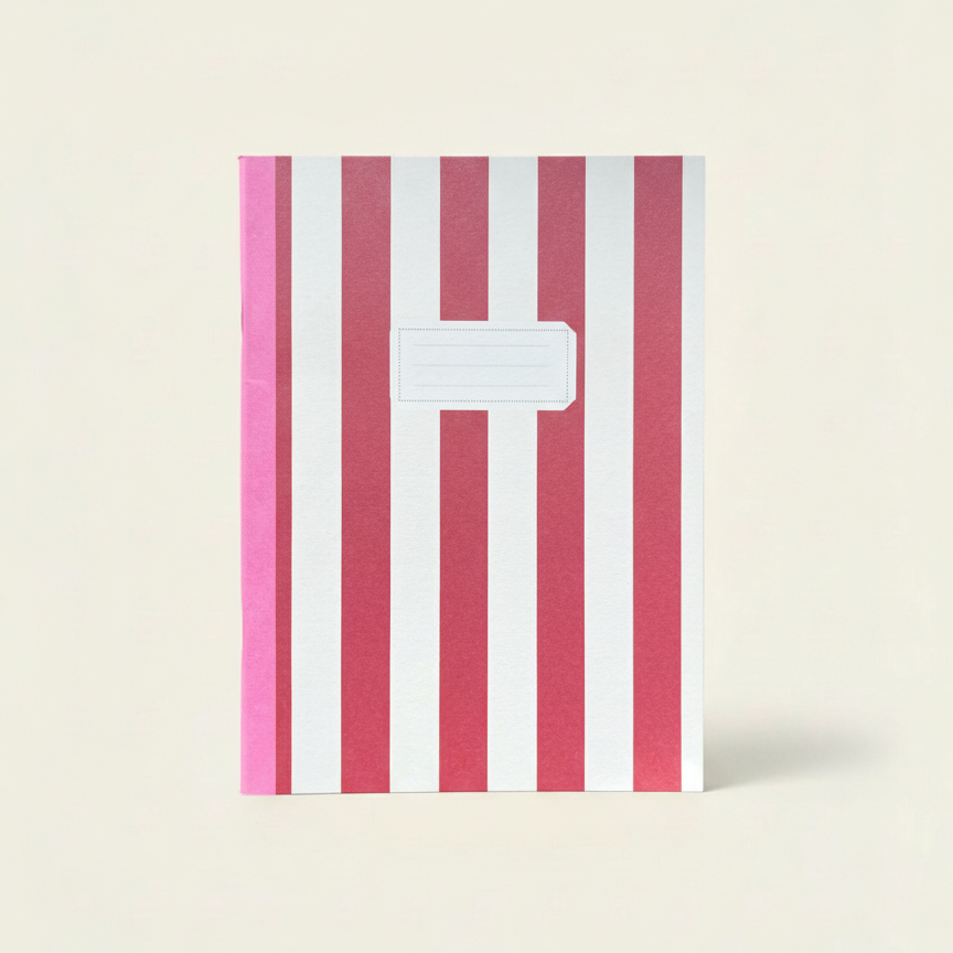 Notebook with pink and white striped cover on a beige background