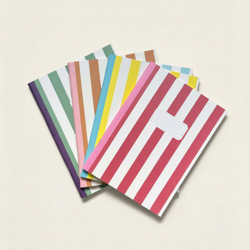 Set of colorful striped notebooks on a beige background