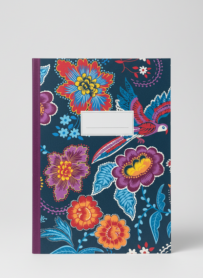 Notebook with colorful floral and bird design on a blue background