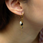 Close-up of an earring with beads worn by a person