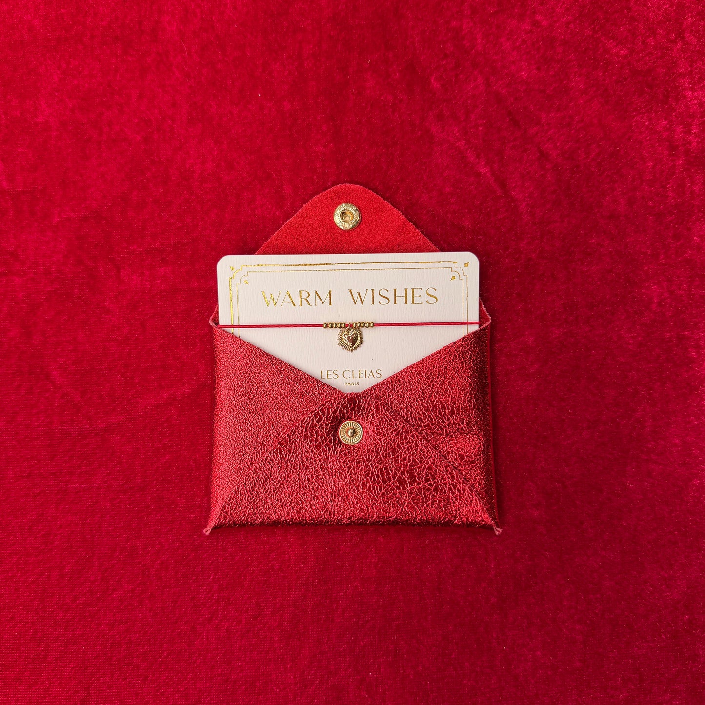 Red textured envelope with a card inside on a matching red background
