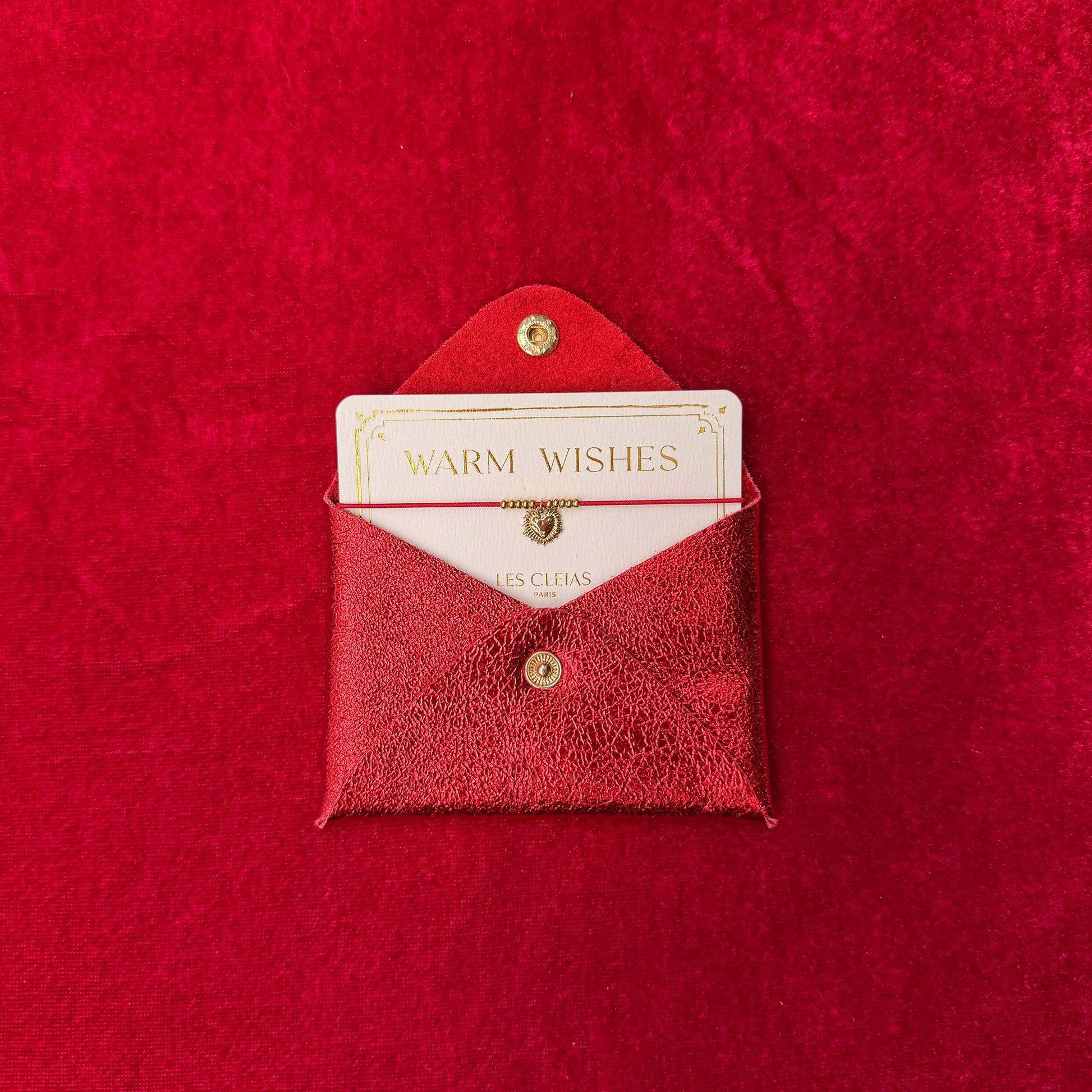 Red textured envelope with a card inside on a matching red background