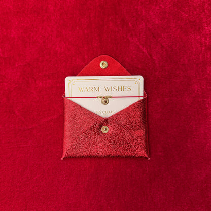 Red textured envelope with a card inside on a matching red background