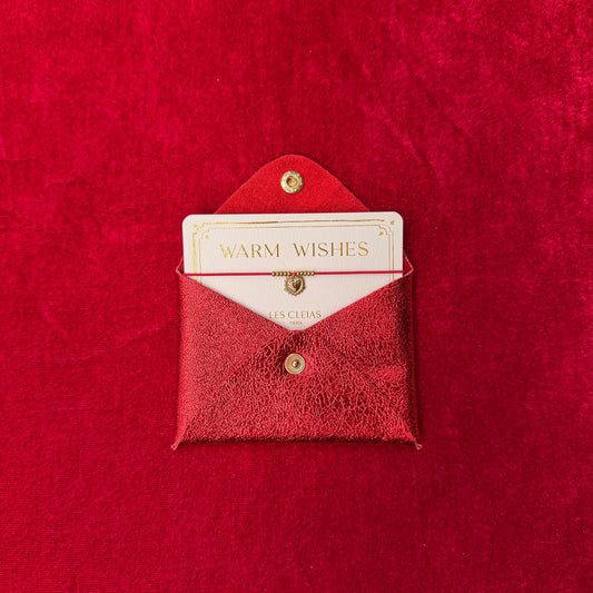 Red textured envelope with a card inside on a matching red background
